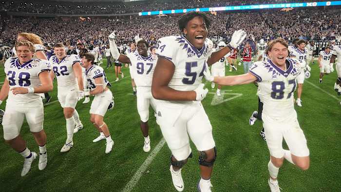 TCU players celebrate after beating Michigan